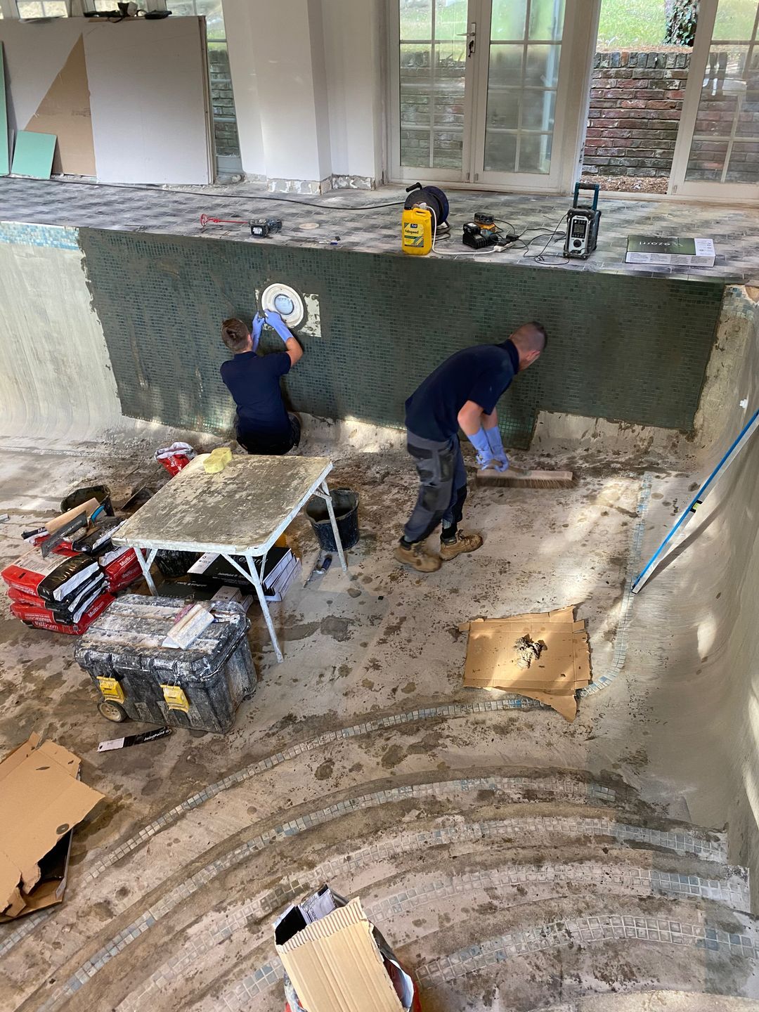 The UK Swimming Pools team is had at work - All debris has to be removed from the swimming pool before the new tiling can start