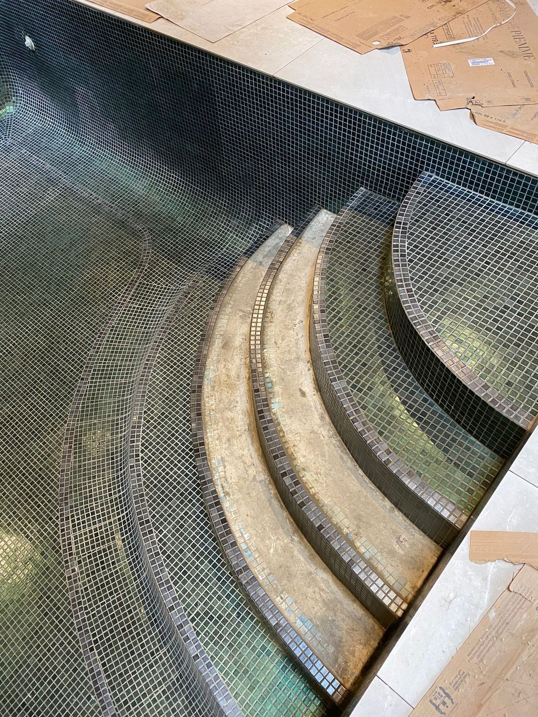 The team of UKSP is tiling the refurbished stairs