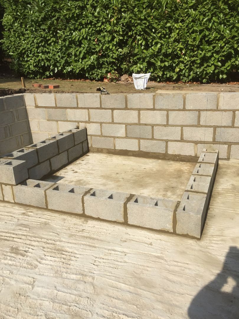 Concrete blocks were used to build the sides of fast flow water-injected spa area that could comfortably seat eight people