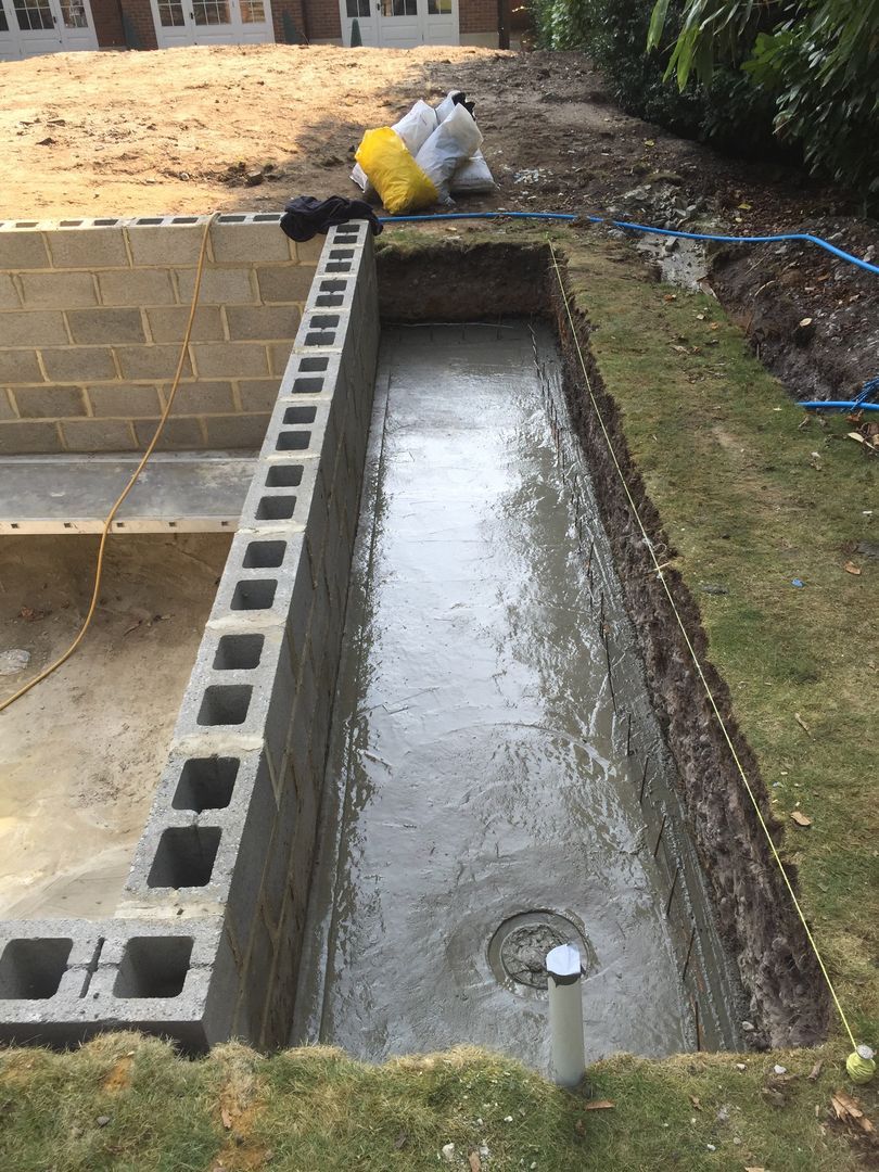 Pouring concrete under the pool cover storage location.