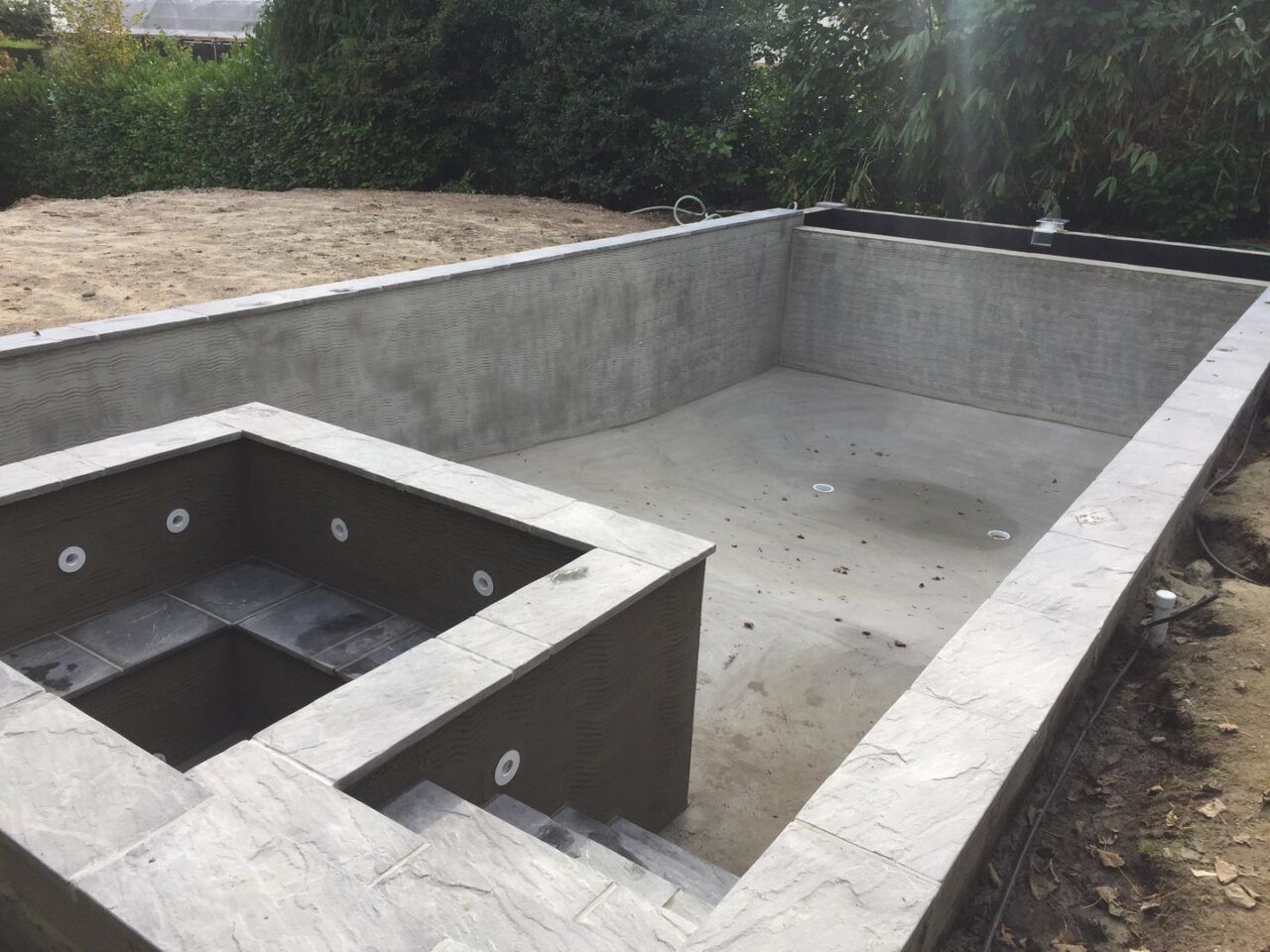 The masonry work has been finished around the entire swimming pool