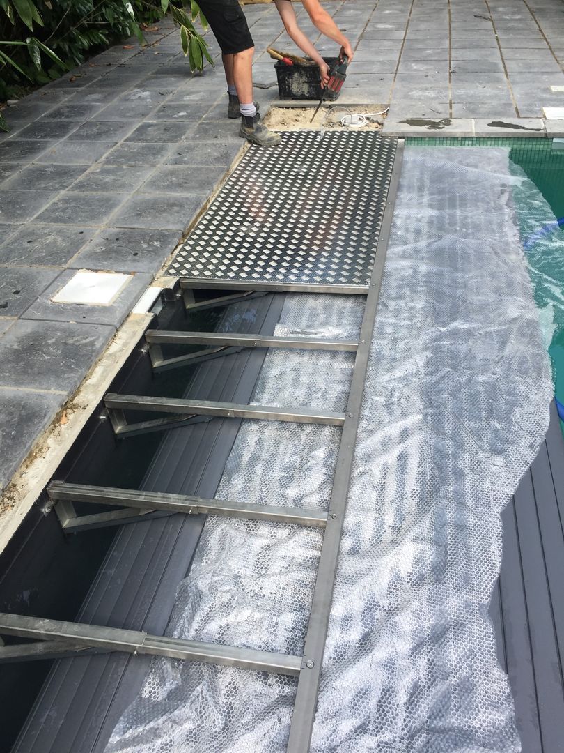 The Swimming pool cover has been installed and the cover is being installed on the top of it