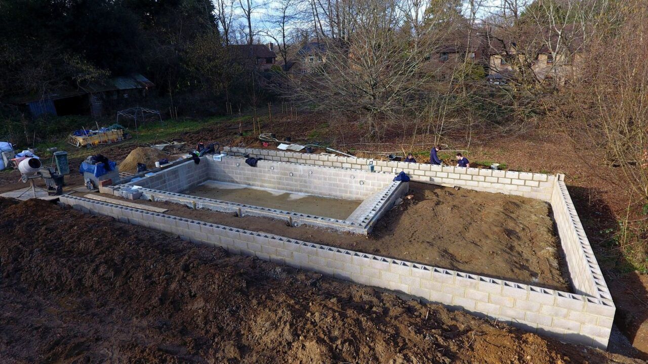 a wide angle view of the pool and surroundings - showing the size of the project