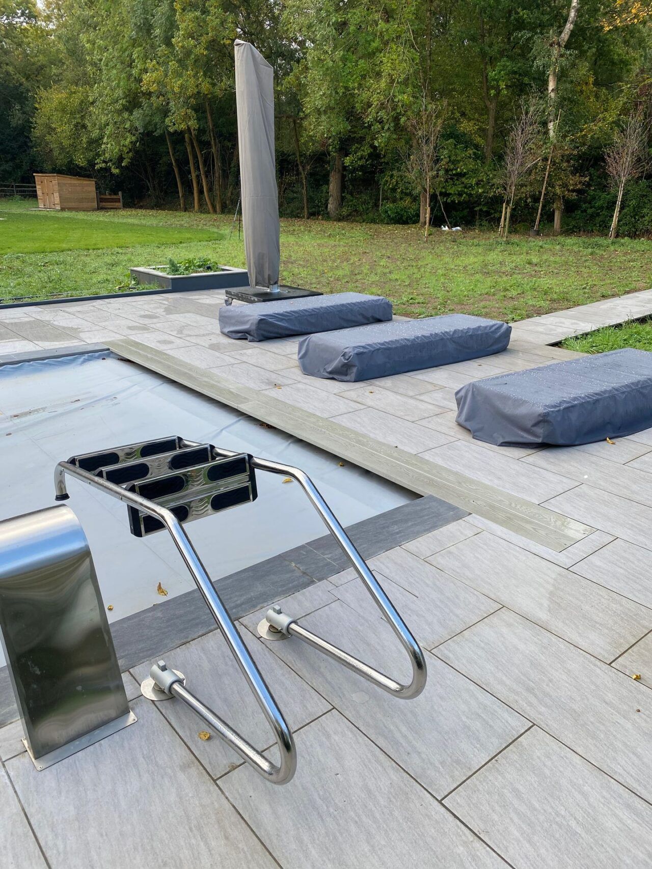 The steps are removed from the swimming pool while the pool cover is on