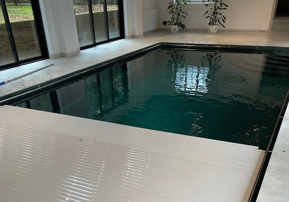 Indoor swimming pool with automated pool cover Indoor swimming pool with automated pool cover