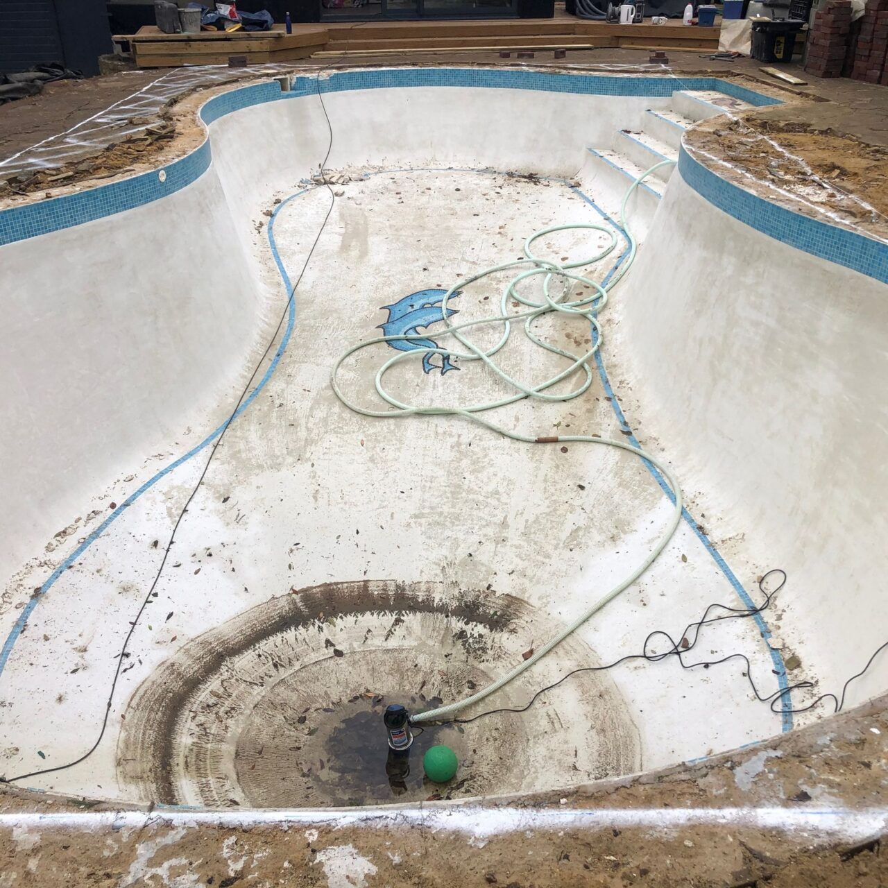 Water was drained and the new shape painted around the edges of the original kidney shaped pool Water was drained and the new shape painted around the edges of the original kidney shaped pool