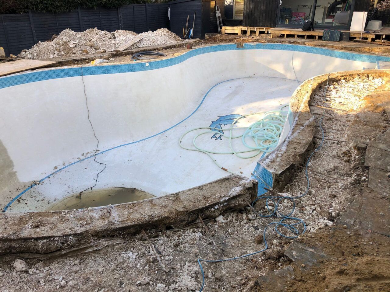 The reshaping work started by removing the original pavement around the pool The reshaping work started by removing the original pavement around the pool