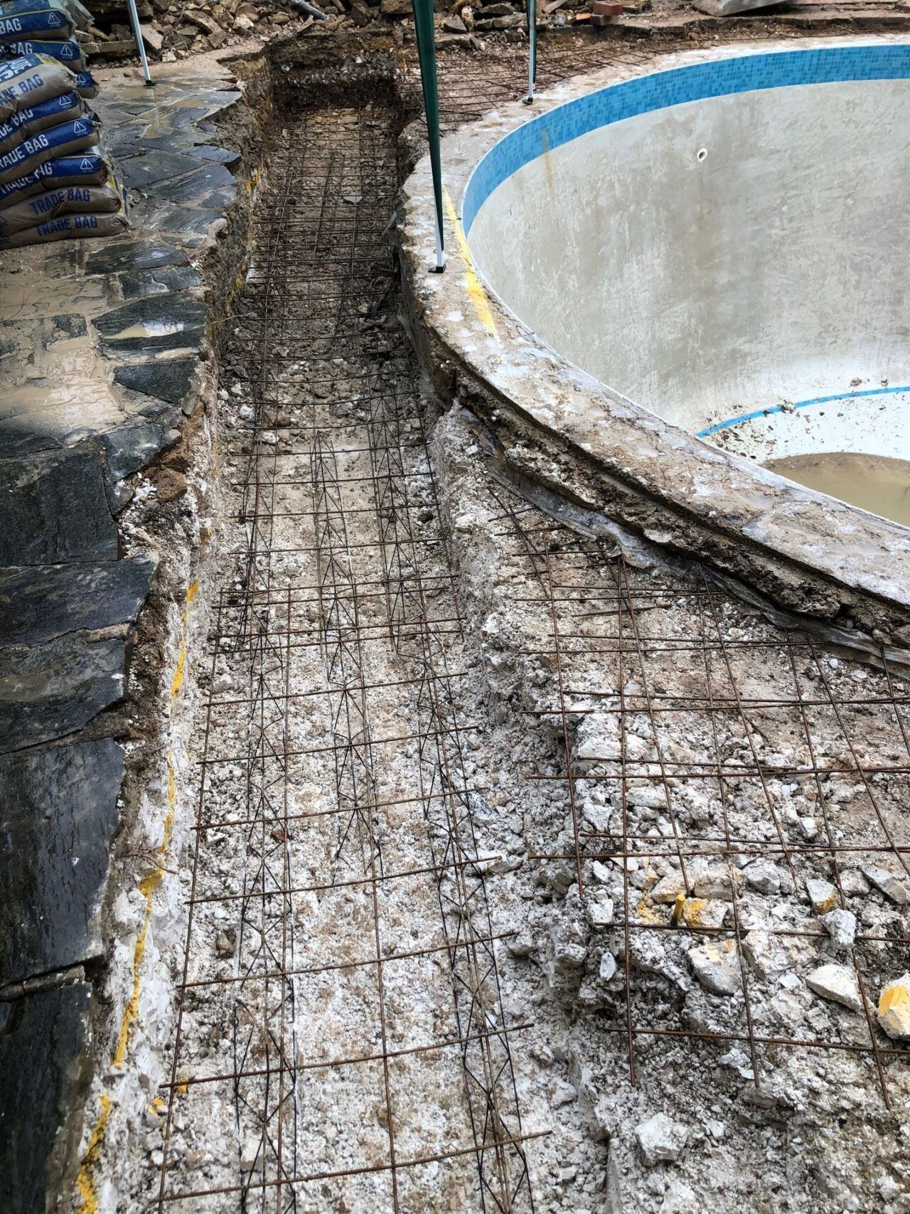 The reshaping work started by removing the original pavement around the pool The reshaping work started by removing the original pavement around the pool