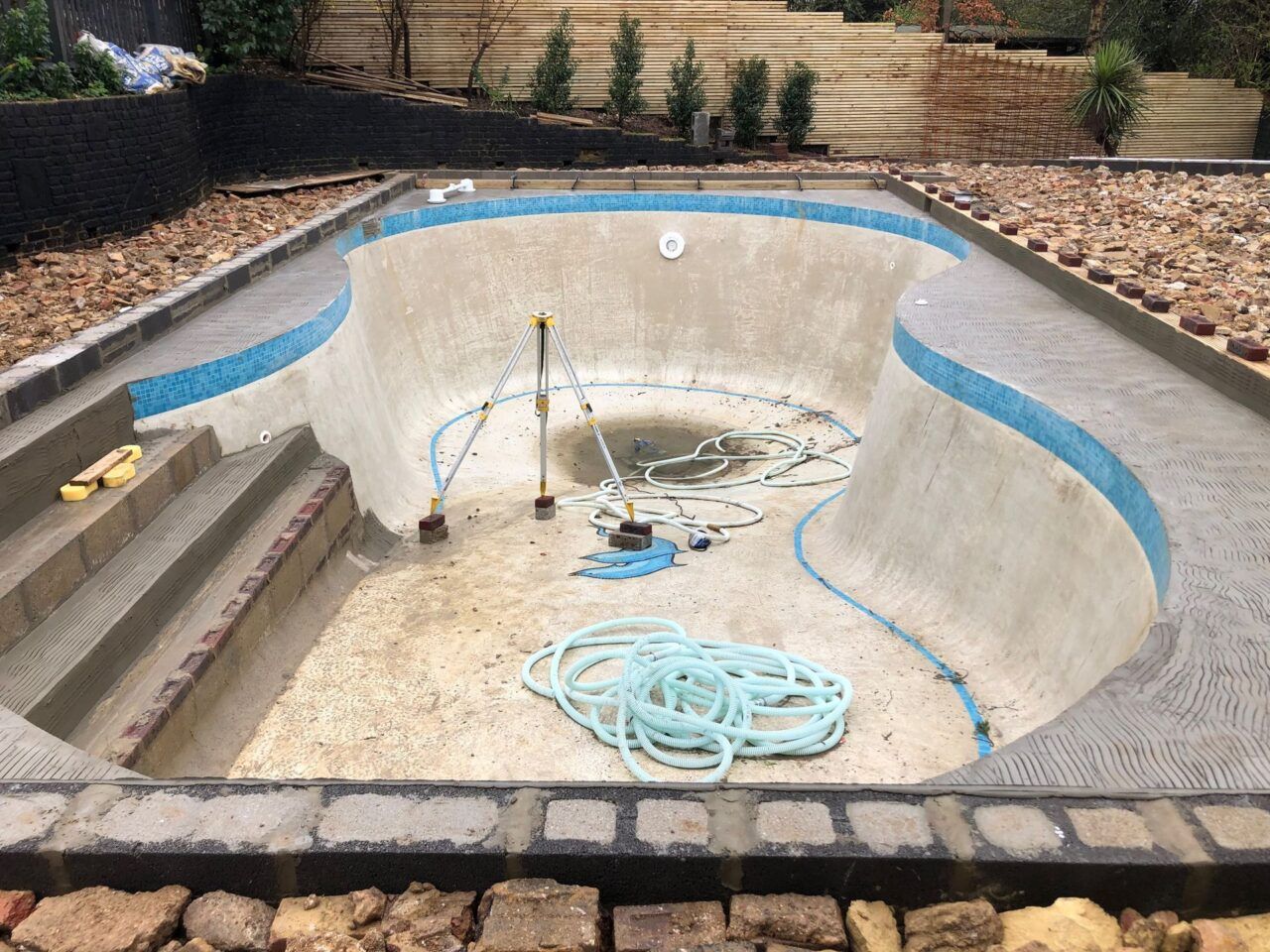The original concrete pool was redesigned into a rectangular shape with integrated beach entries on two sides to facilitate supervised child access The original concrete pool was redesigned into a rectangular shape with integrated beach entries on two sides to facilitate supervised child access