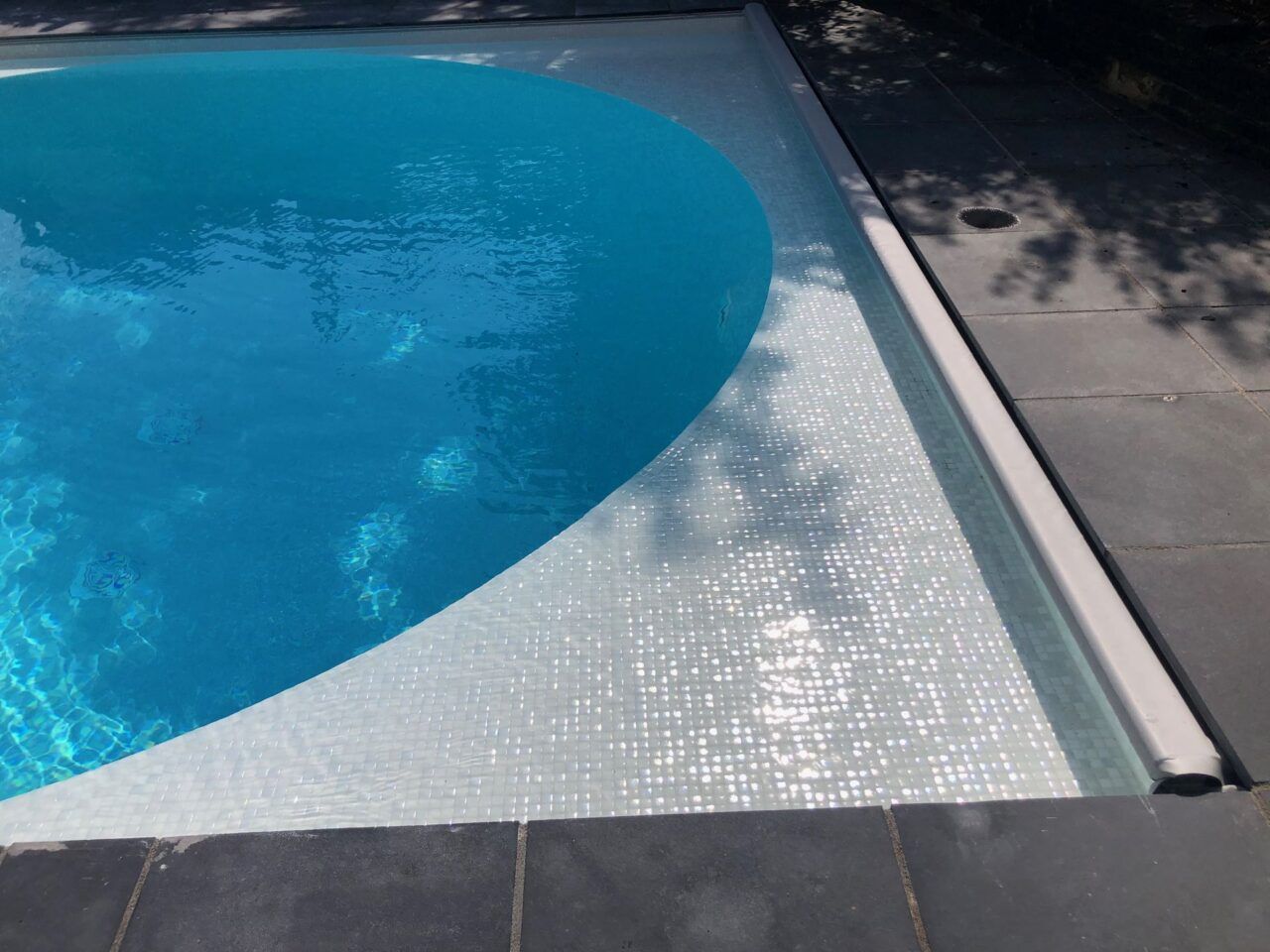 Close-up of the edge of the new swimming pool showing the automated cover location Close-up of the edge of the new swimming pool showing the automated cover location