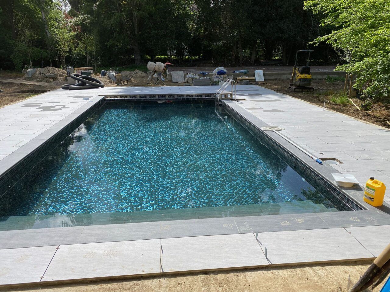 The swimming pool has been filled up and the limestone paving is being installed