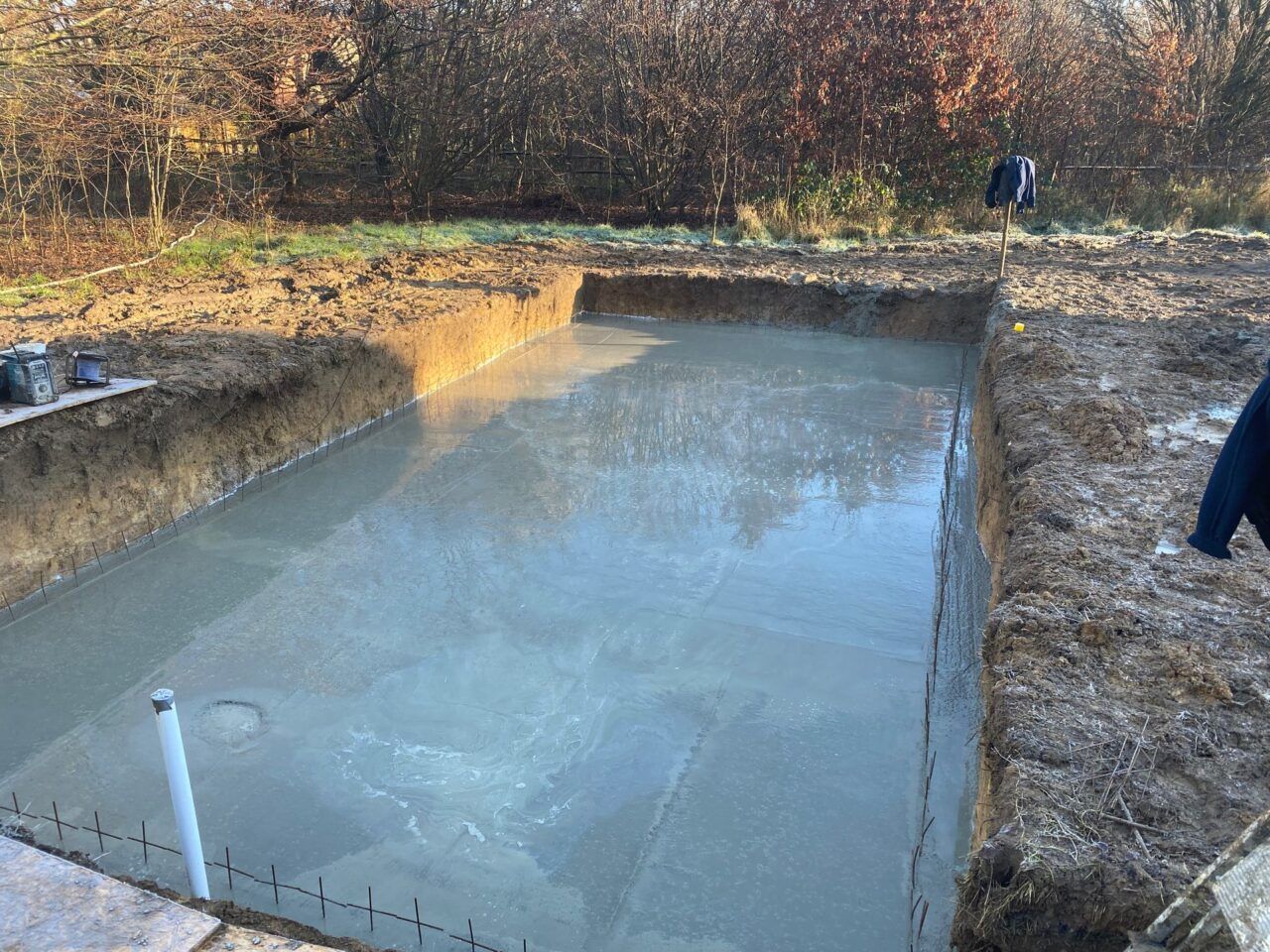 A layer of concrete poured over the metal wire frame creating an even surface for the swimming pool