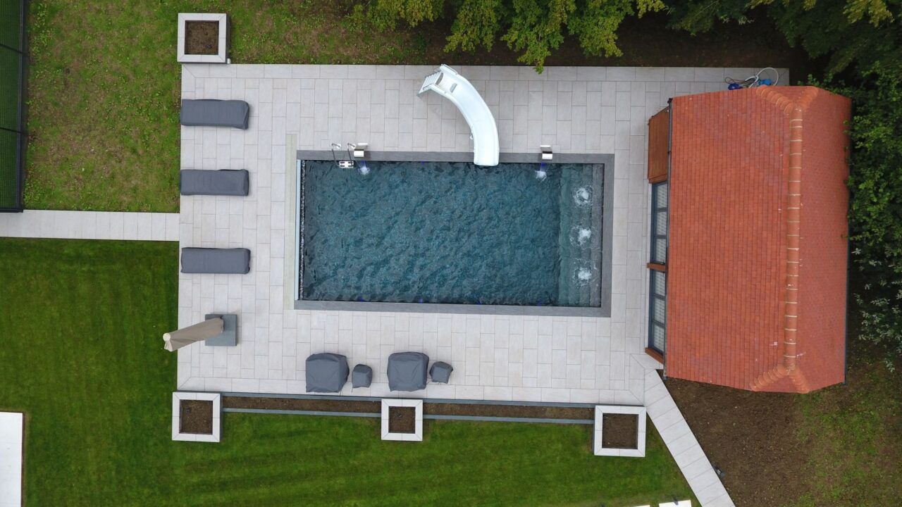 Drone shot of the finished project of this Luxury Swimming Pool by UK Swimming Pools Ltd