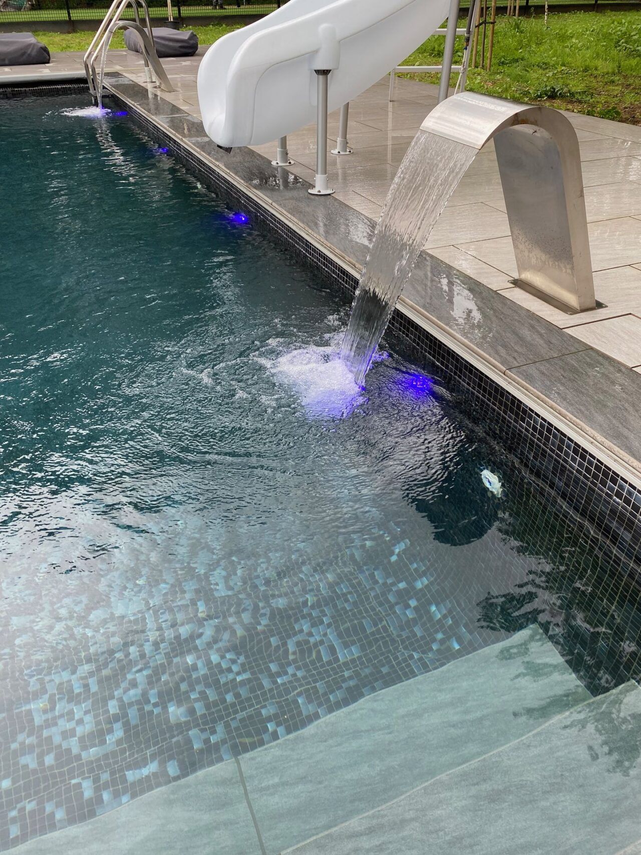 Close-up shot of the swimming pool and the elegant water fountains