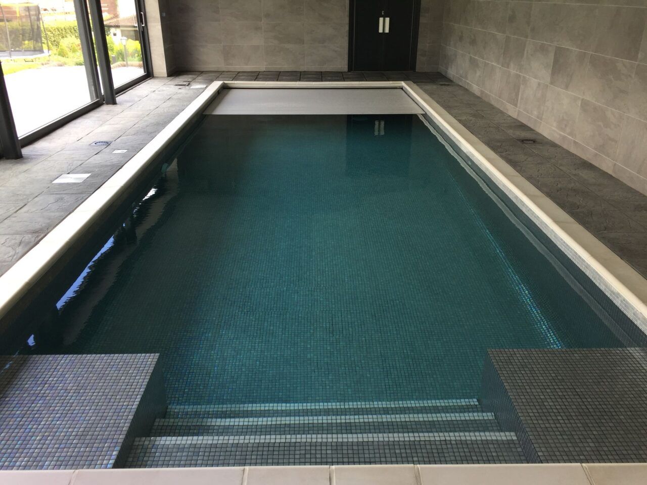 Integrated pool cover over the newly refurbished swimming pool