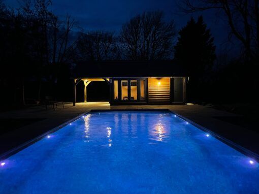 Night shot of the finished luxury pool with pool house