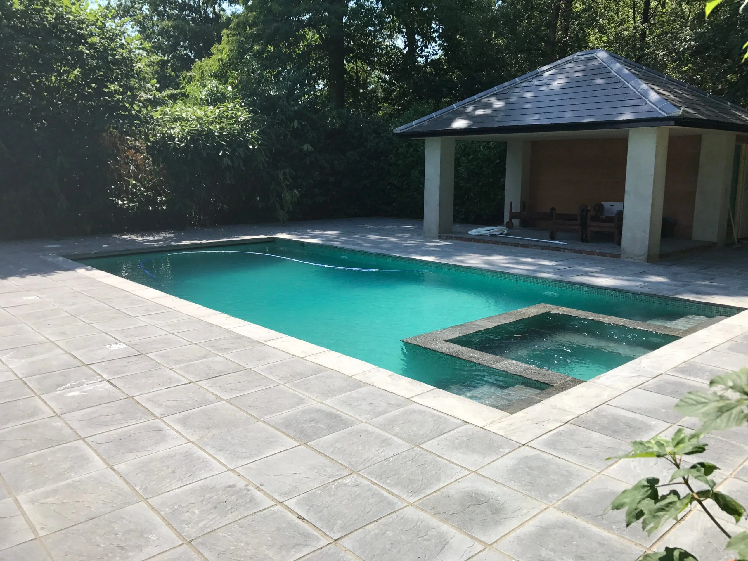 The new outdoor kitchen by the swimming pool with spa