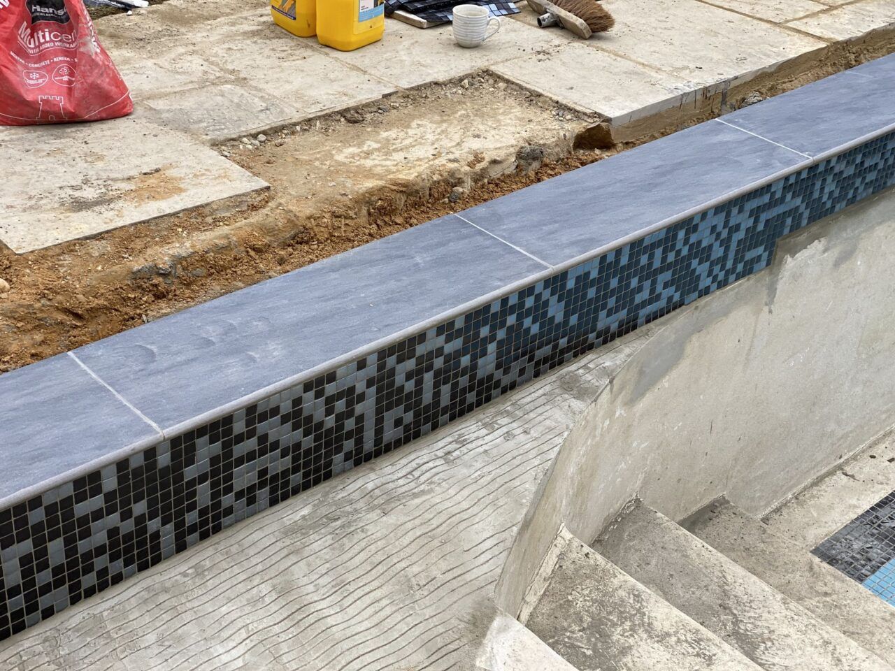 Close up of the new mosaic tiled band to the refurbished swimming pool Close up of the new mosaic tiled band to the refurbished swimming pool