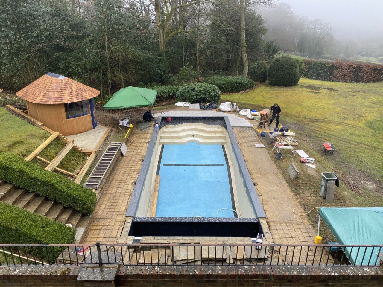 Swimming pool refurbishment showing the reinforced concrete base prior to patio being laid Swimming pool refurbishment showing the reinforced concrete base prior to patio being laid