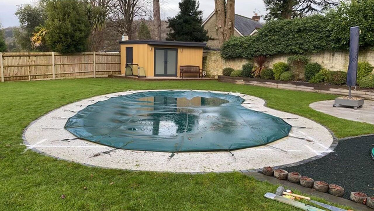 A manual pool cover over the original swimming pool A manual pool cover over the original swimming pool